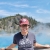 Person standing in front of hotsprings smiling at camera