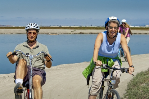 people riding bikes on a beach