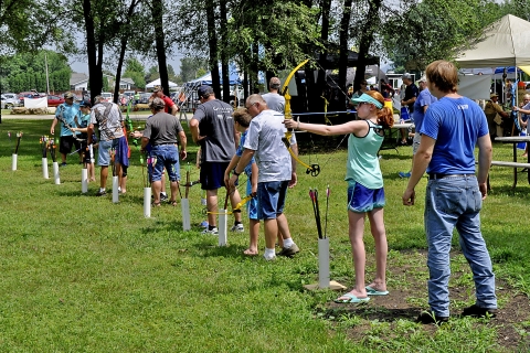 Children practice archery at the Youth Outdoor Fest in La Crosse