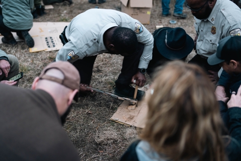 A man demonstrates how to start a fire with sticks