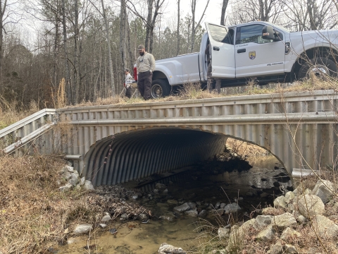 Service biologists examine the arched bottomless culvert at Smith Creek in Calhoun County, Mississippi.