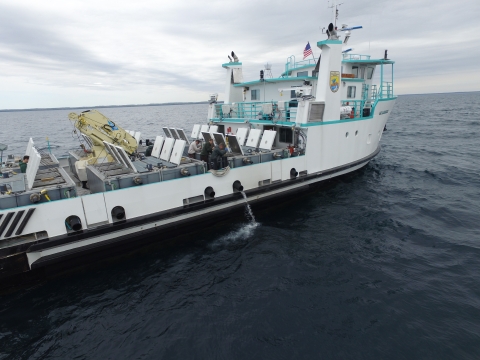 Large fish stocking and research vessel on the water.